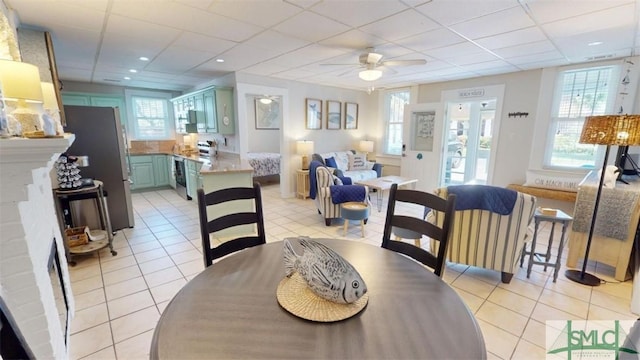 403 13th St, Tybee Island, GA 31328 - tiled dining area featuring ceiling fan, a healthy amount of sunlight, and a drop ceiling