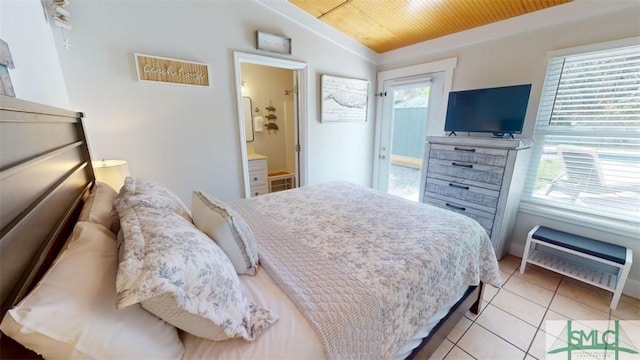 403 13th St, Tybee Island, GA 31328 - tiled bedroom featuring multiple windows, lofted ceiling, and connected bathroom