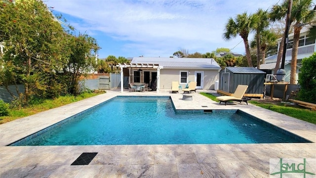403 13th St, Tybee Island, GA 31328 - view of pool with an outbuilding, a patio area, and a pergola