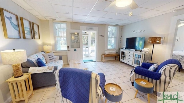 403 13th St, Tybee Island, GA 31328 - living room featuring a drop ceiling and light tile patterned floors