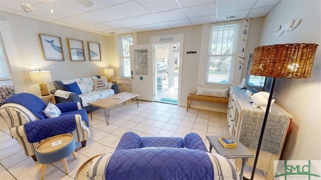 403 13th St, Tybee Island, GA 31328 - tiled living room featuring a paneled ceiling and plenty of natural light
