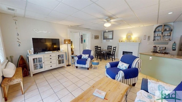 403 13th St, Tybee Island, GA 31328 - living room with ceiling fan, a paneled ceiling, and tile patterned flooring