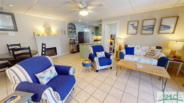 403 13th St, Tybee Island, GA 31328 - living room featuring a paneled ceiling, ceiling fan, and light tile patterned floors