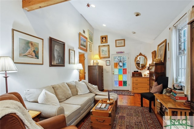 living area featuring recessed lighting, lofted ceiling, and wood finished floors