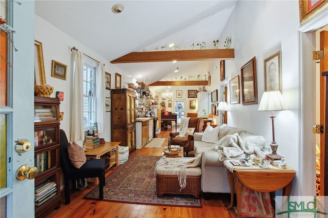 living room with lofted ceiling and wood finished floors