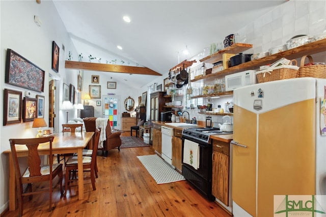 kitchen with light wood-style flooring, open shelves, a sink, white appliances, and lofted ceiling