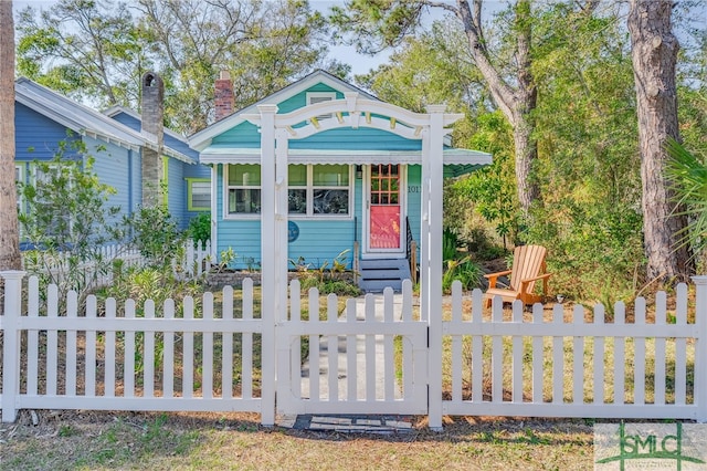 view of outdoor structure featuring entry steps and a fenced front yard