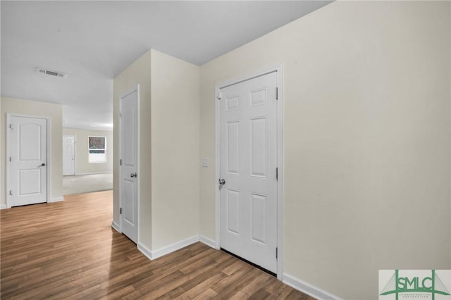 hall with hardwood / wood-style floors