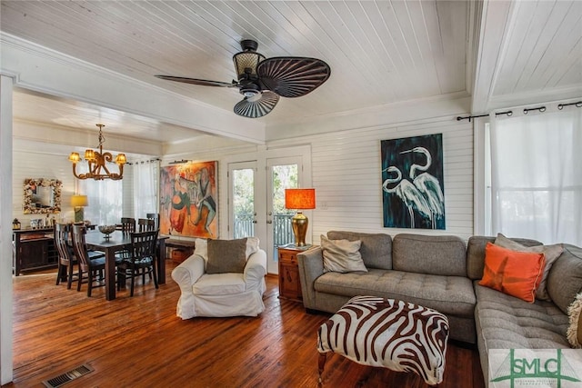 living room with ornamental molding, wood-type flooring, ceiling fan with notable chandelier, and wooden ceiling