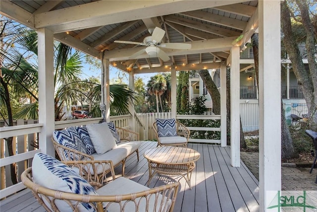 sunroom with lofted ceiling with beams and ceiling fan