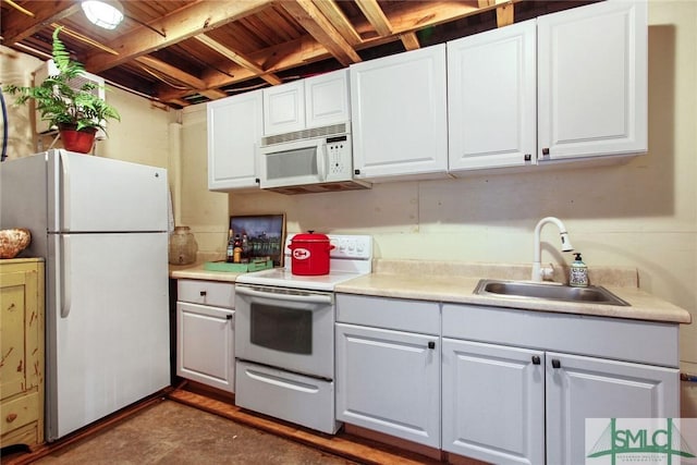 kitchen with white cabinetry, sink, and white appliances