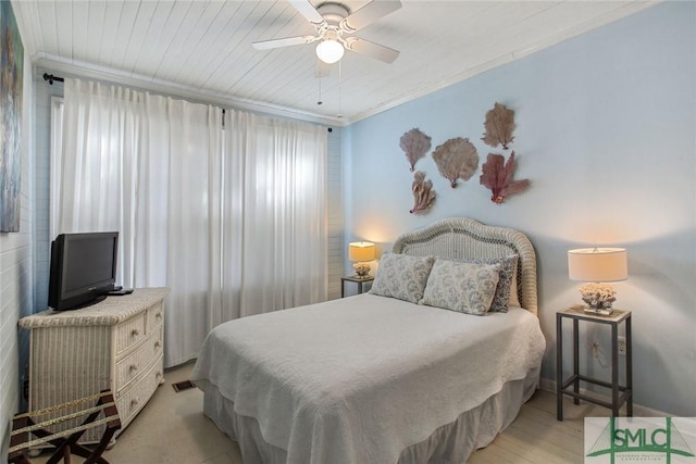 bedroom with ornamental molding, ceiling fan, and light wood-type flooring