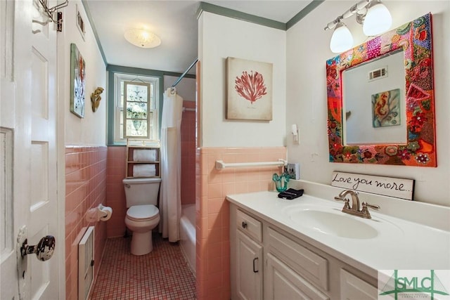 full bathroom featuring vanity, toilet, tile patterned flooring, and tile walls