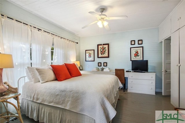 bedroom with dark hardwood / wood-style floors and ceiling fan