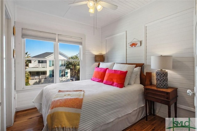 bedroom with ceiling fan and dark hardwood / wood-style flooring