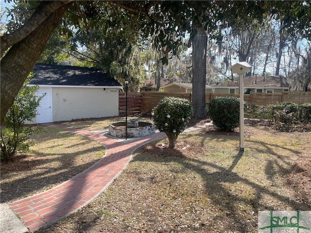 view of yard with an outdoor fire pit