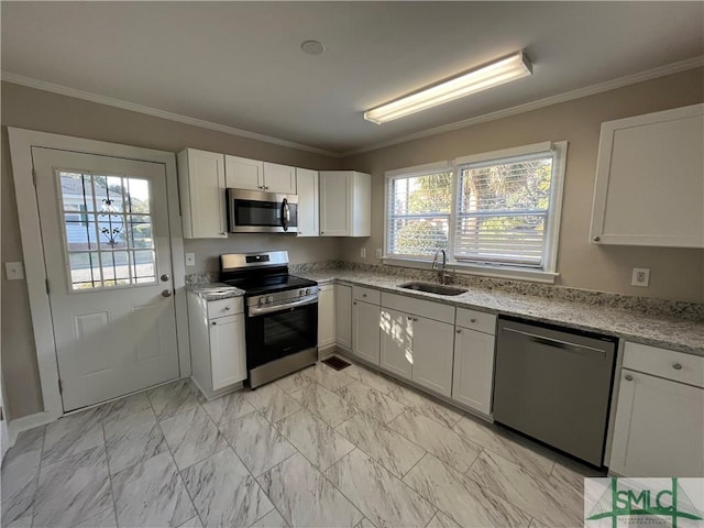 kitchen with appliances with stainless steel finishes, sink, and white cabinets