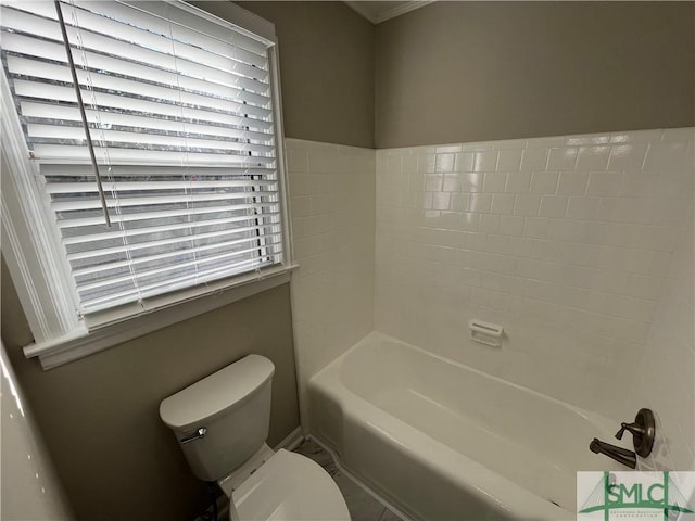 bathroom with a washtub and toilet