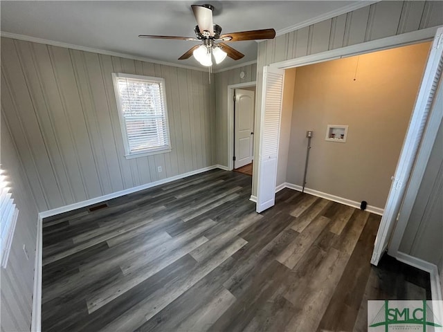 unfurnished bedroom with ornamental molding, dark hardwood / wood-style floors, and ceiling fan