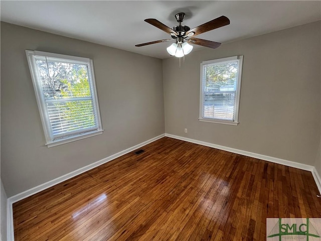 empty room with hardwood / wood-style floors and ceiling fan