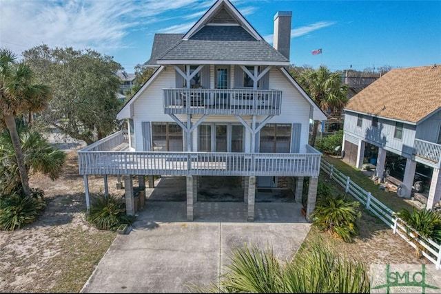 view of front of house featuring a balcony and a carport