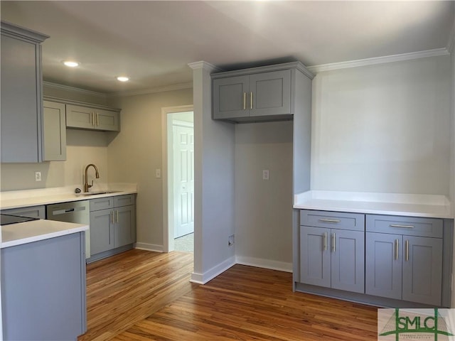 kitchen with sink, ornamental molding, dark hardwood / wood-style floors, gray cabinets, and dishwasher