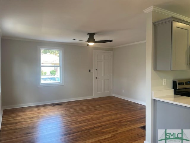 interior space featuring crown molding, ceiling fan, and dark hardwood / wood-style flooring