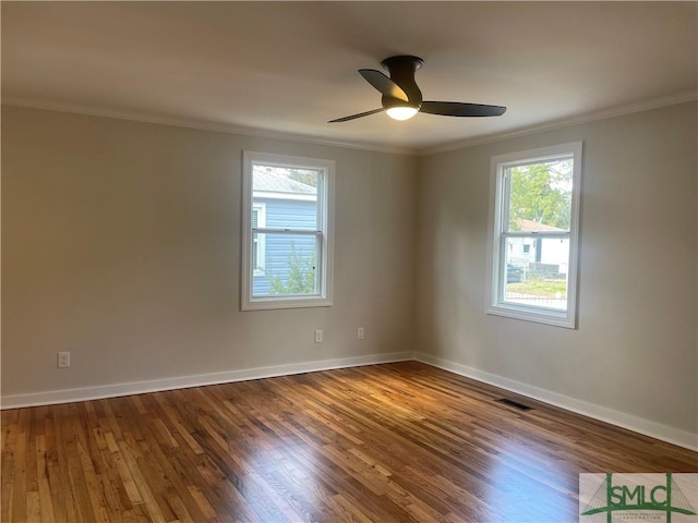 empty room featuring crown molding, hardwood / wood-style flooring, and ceiling fan