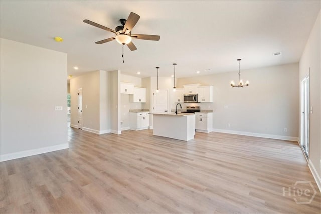 330 Crosswinds Dr, Rincon, GA 31326 - unfurnished living room with a chandelier, a ceiling fan, light wood-type flooring, baseboards, and recessed lighting