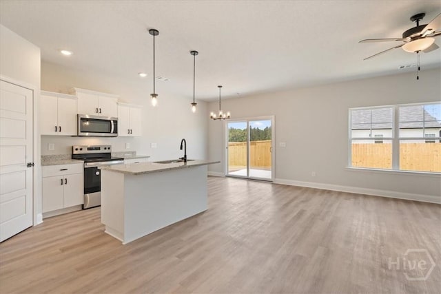 330 Crosswinds Dr, Rincon, GA 31326 - kitchen with stainless steel appliances, light wood-type flooring, ceiling fan, a chandelier, and open floor plan