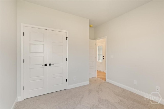 330 Crosswinds Dr, Rincon, GA 31326 - unfurnished bedroom featuring light colored carpet, a closet, and baseboards