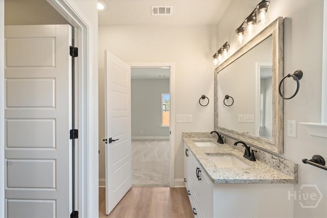 330 Crosswinds Dr, Rincon, GA 31326 - bathroom featuring wood finished floors, double vanity, and baseboards