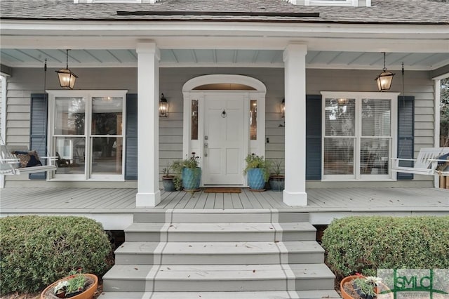 doorway to property featuring covered porch