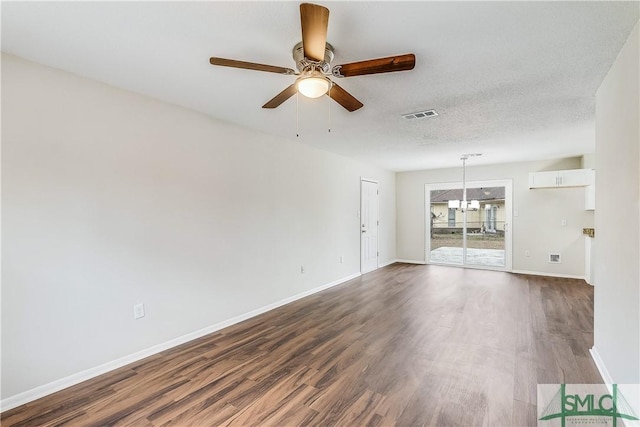 unfurnished room featuring ceiling fan with notable chandelier, hardwood / wood-style floors, and a textured ceiling