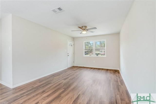 empty room featuring hardwood / wood-style floors and ceiling fan