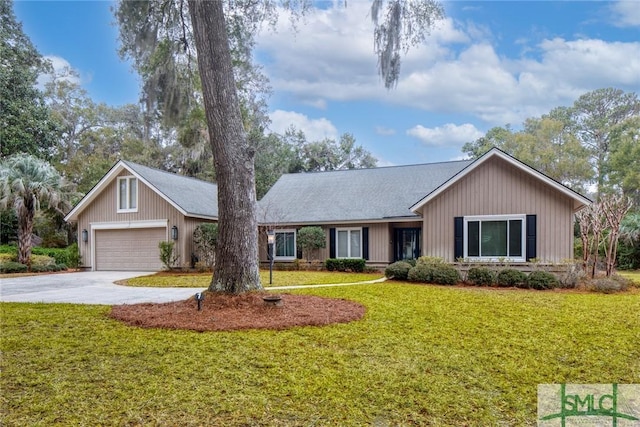 single story home featuring a garage and a front lawn