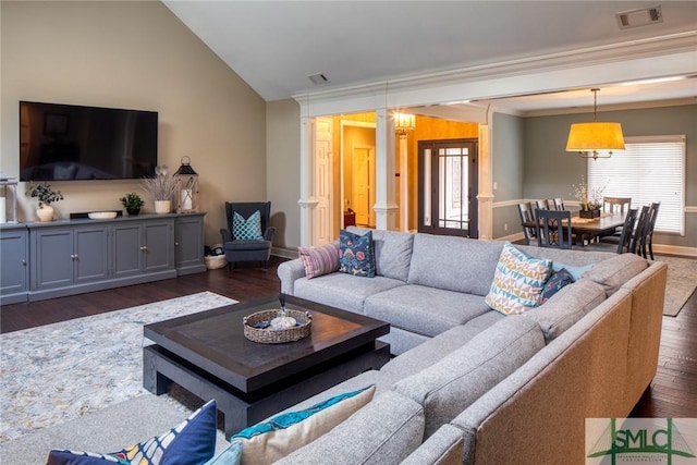 living room with decorative columns, vaulted ceiling, crown molding, and dark hardwood / wood-style flooring