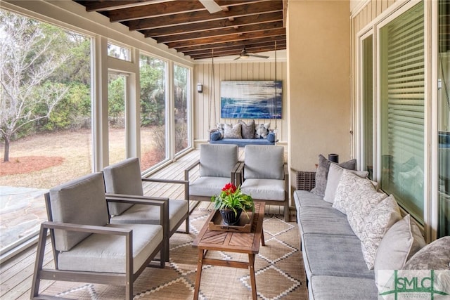 sunroom / solarium with beamed ceiling and ceiling fan