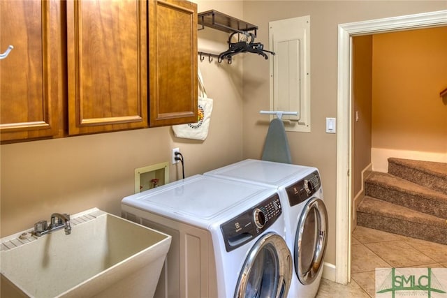 clothes washing area with cabinets, separate washer and dryer, sink, and light tile patterned floors