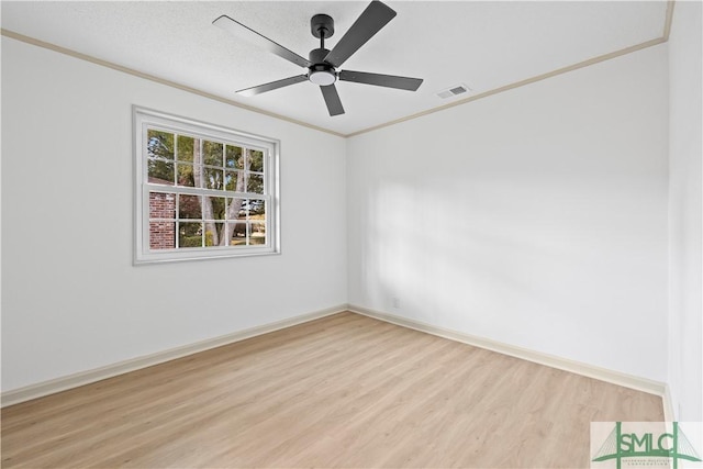 unfurnished room with visible vents, baseboards, light wood-style flooring, ceiling fan, and ornamental molding