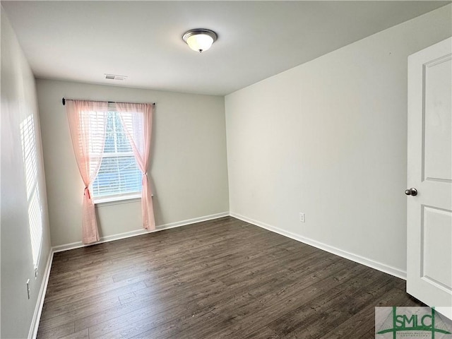 spare room with dark hardwood / wood-style floors