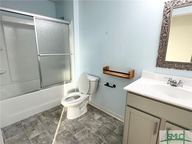 full bathroom with enclosed tub / shower combo, vanity, and toilet