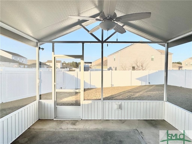 unfurnished sunroom with lofted ceiling and ceiling fan