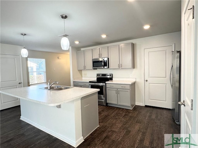 kitchen with pendant lighting, stainless steel appliances, sink, and gray cabinetry