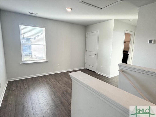 spare room featuring dark wood-type flooring