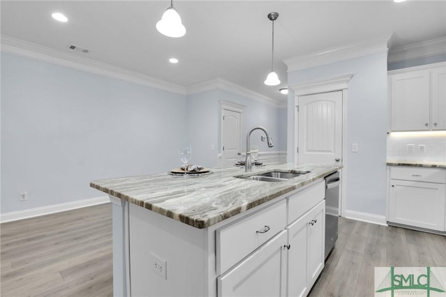 kitchen featuring sink, white cabinetry, a center island with sink, stainless steel dishwasher, and light stone countertops