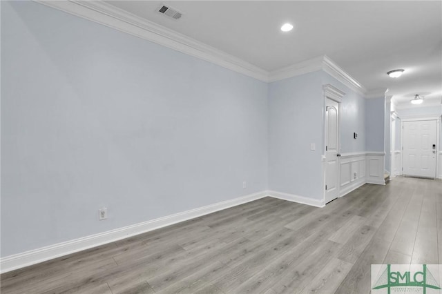 unfurnished room featuring ornamental molding and light hardwood / wood-style floors