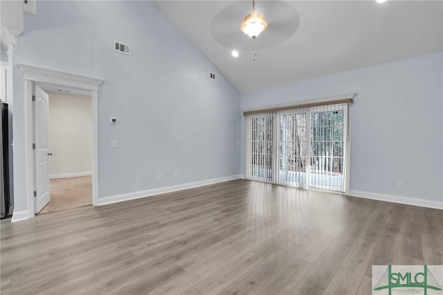 unfurnished living room featuring ceiling fan, high vaulted ceiling, and light hardwood / wood-style flooring