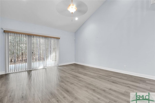 spare room featuring light hardwood / wood-style flooring, ceiling fan, and vaulted ceiling