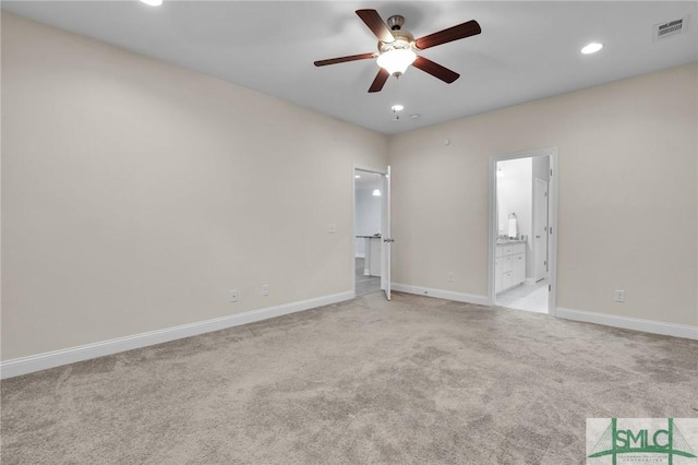 empty room featuring light colored carpet and ceiling fan